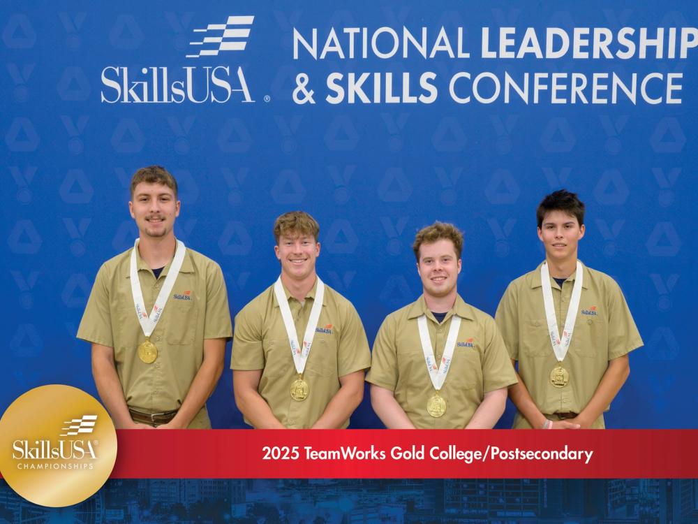 Four students stand in a row with gold medals around their necks. Behind them is a blue background with the SillsUSA logo and the words "National Leadership & Skills Conference." Below them is a red banner that reads "2025 TeamWorks Gold College/Postsecondary."