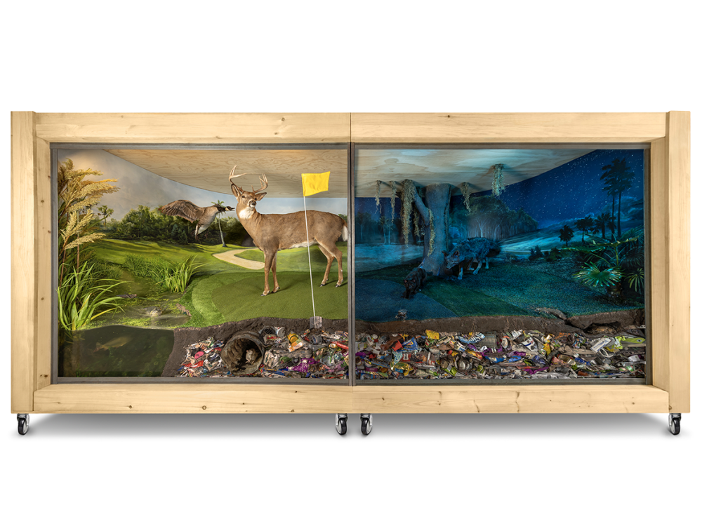 Large sculptural diorama of a golf course in the day at night
