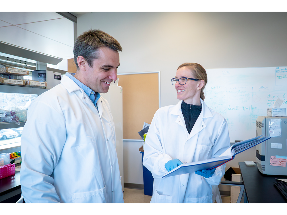 Two people standing in a laboratory