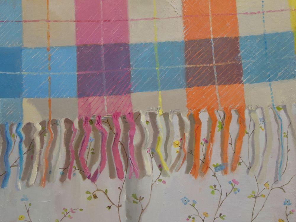 Painting of a colorful plaid fabric with bright blue, pink, orange, and beige squares. The fabric ends in long, multicolored fringe strands that hang down. Beneath the fringe is a pale background with delicate floral vines and small blossoms in pink, blue, and yellow.