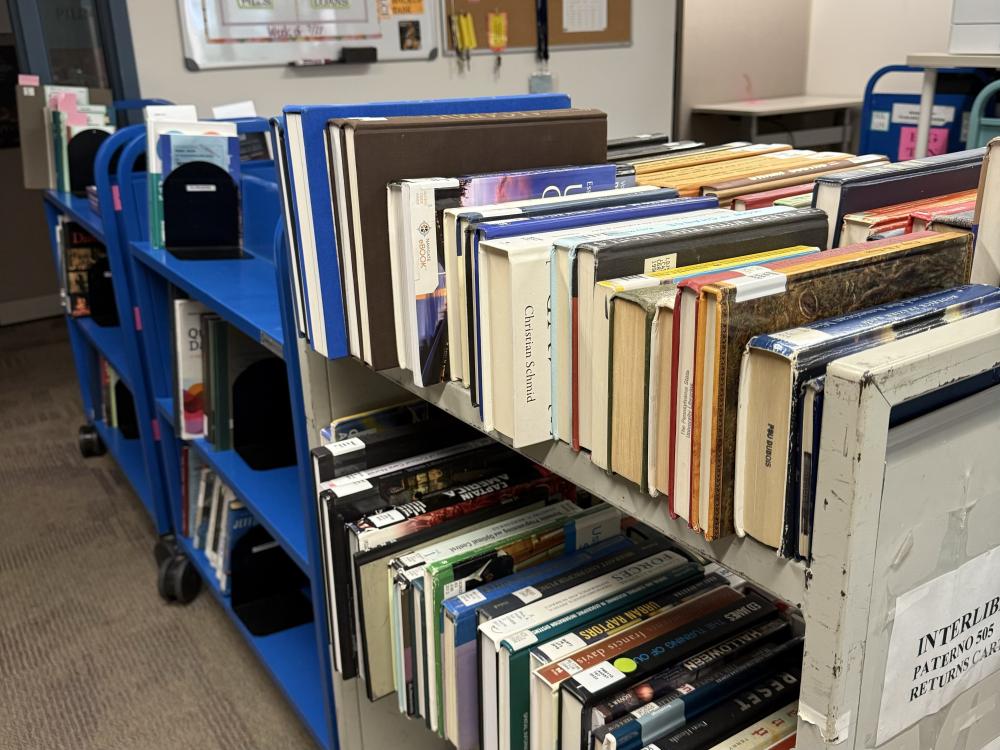 Photo of book cart loaded with books to be loaned to other libraries