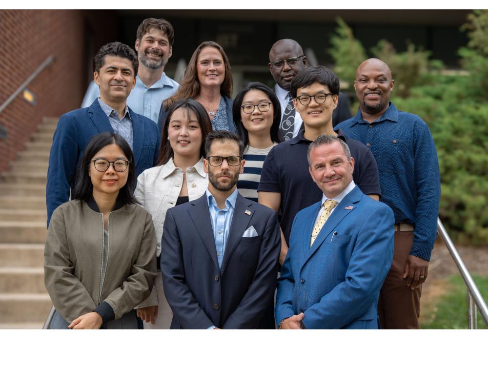 11 college professors outside campus building