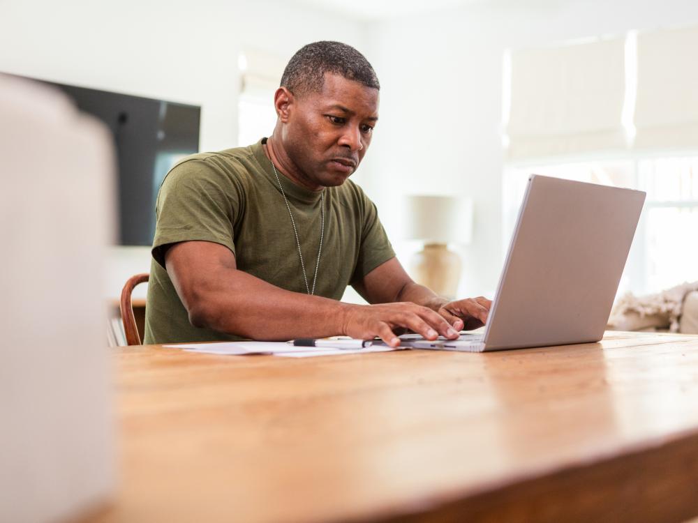 Veteran filling out a form on a computer.