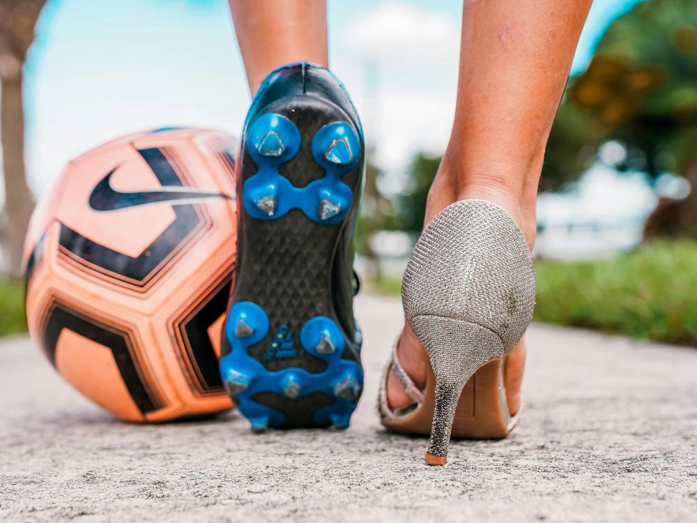 soccer ball, sneakers and high heels