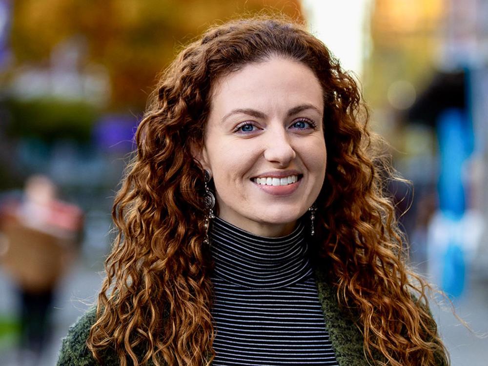 Smiling woman with curly shoulder length red hair