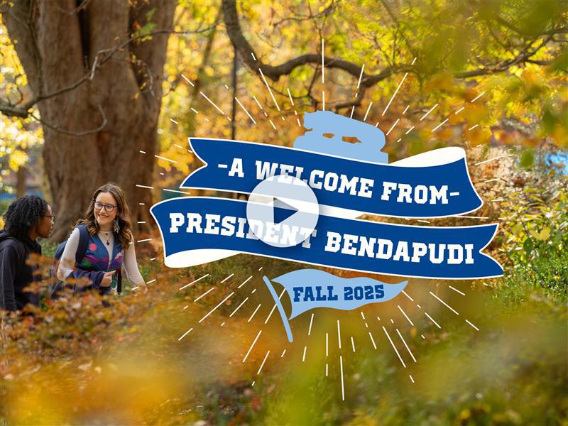 Text reads "A Welcome From President Bendapudi, Fall 2025" over top of a photo of a fall scene with trees, foliage and two women seated in the grass.