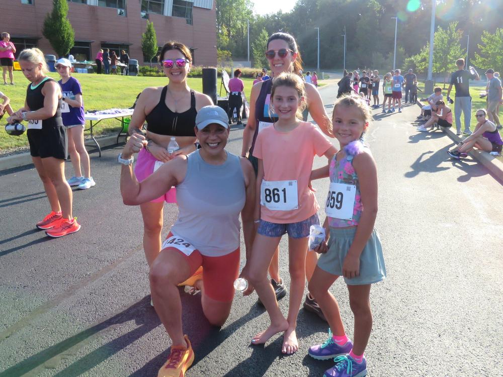 A group of women and young girls pose at Penn State Behrend's annual Run for Women 5K.
