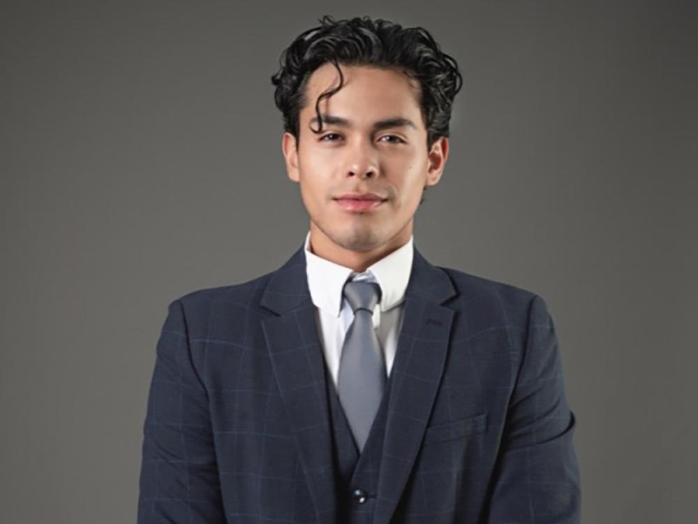 A head and shoulders photo of Carlos Fernando Chacon in a suit and tie