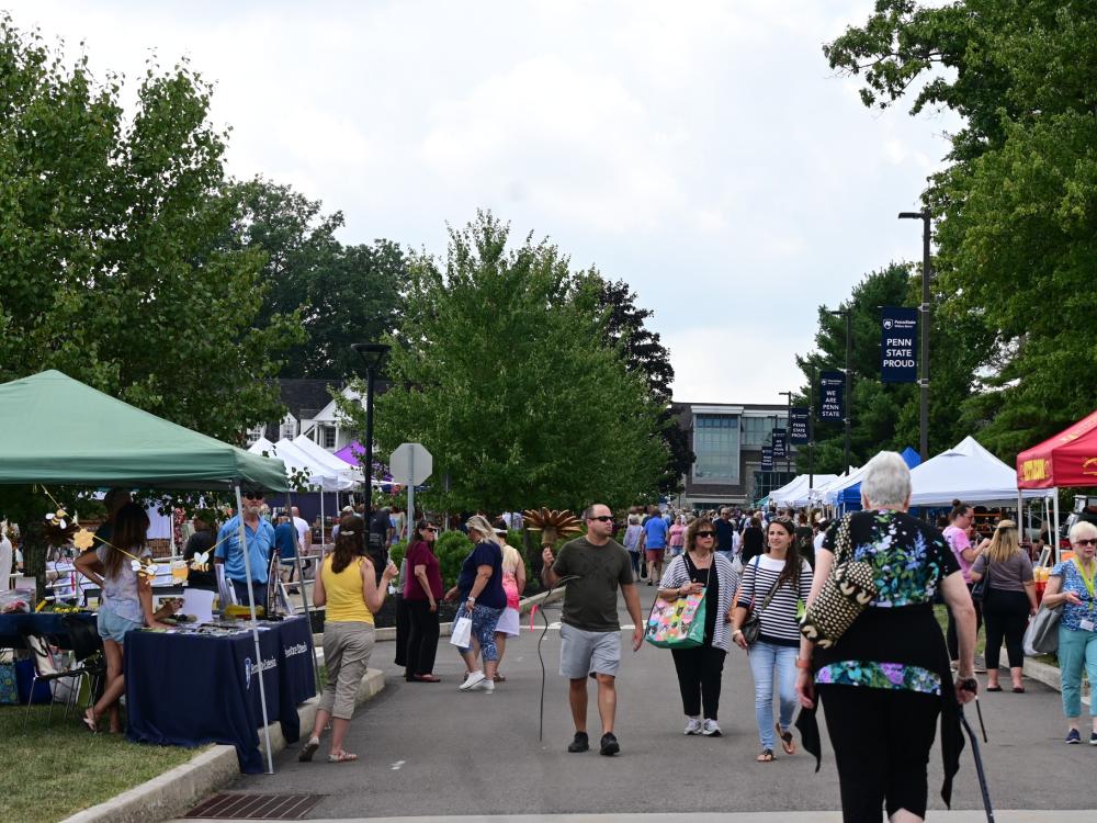 A group of attendees walking outside during a past Summer Arts Festival