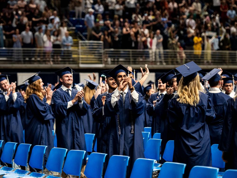 People waving and smiling to the crowd.