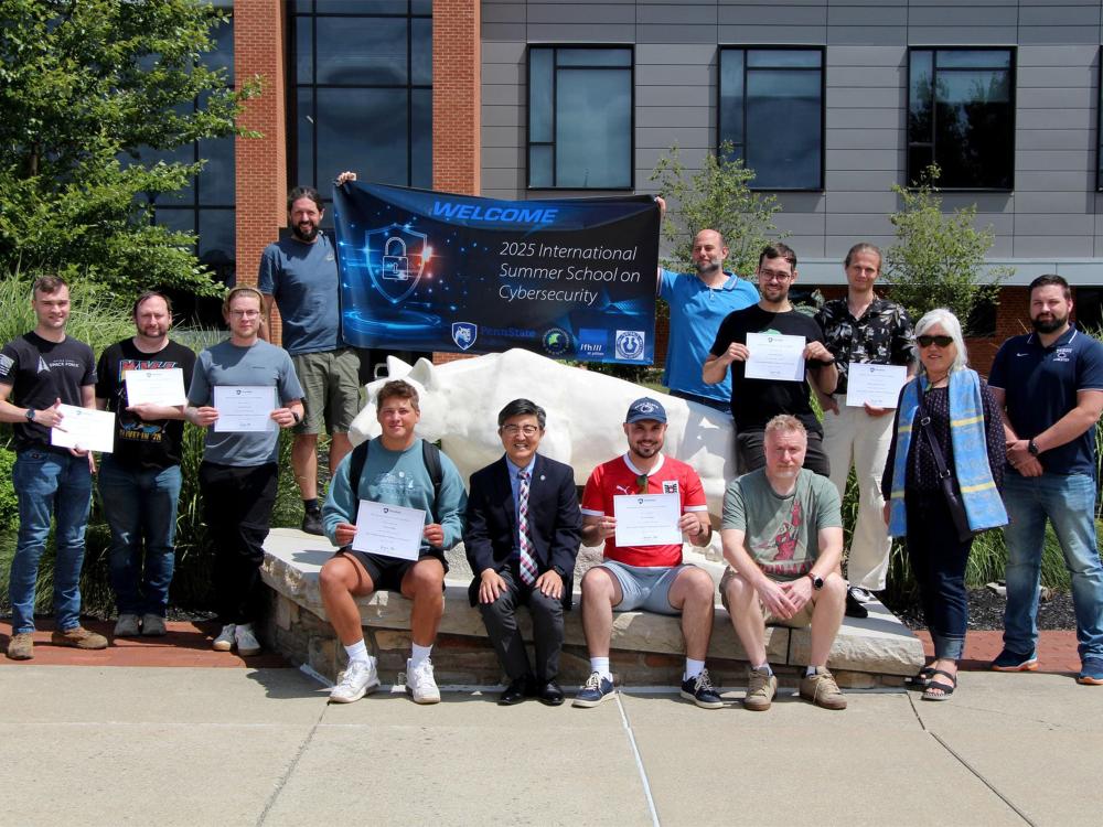 Group of participants pose with certificates in front of the Nittany Lion Shrine at Penn State DuBois’s 2025 Cybersecurity Summer School.
