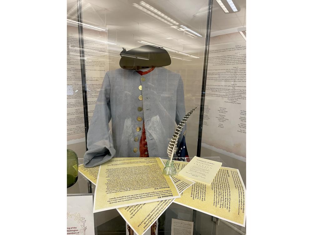 A display showing an historical costume and documents