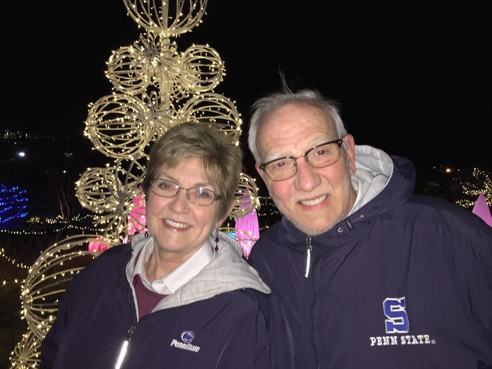 A smiling man and women in winter jackets posing for a photo