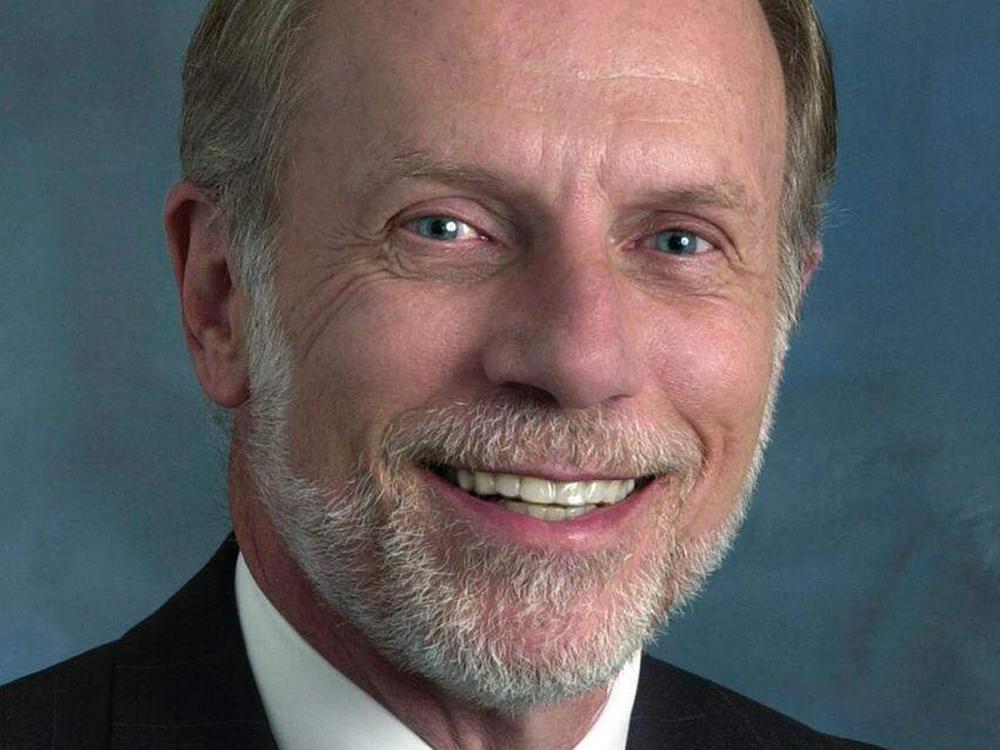 Smiling man with a graying beard