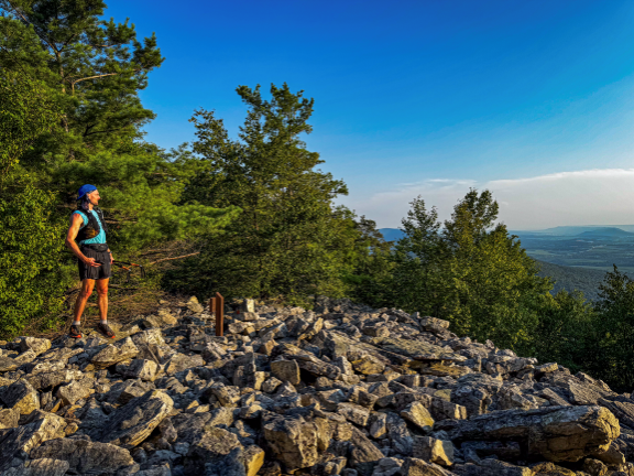 Medical student David Millar stands at a rocky mountain outcropping, gazing at the valley below.