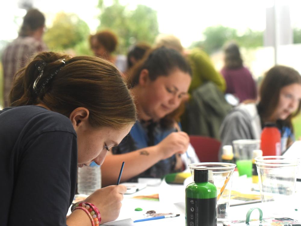Students paint rocks during a wellness event at Penn State Behrend.