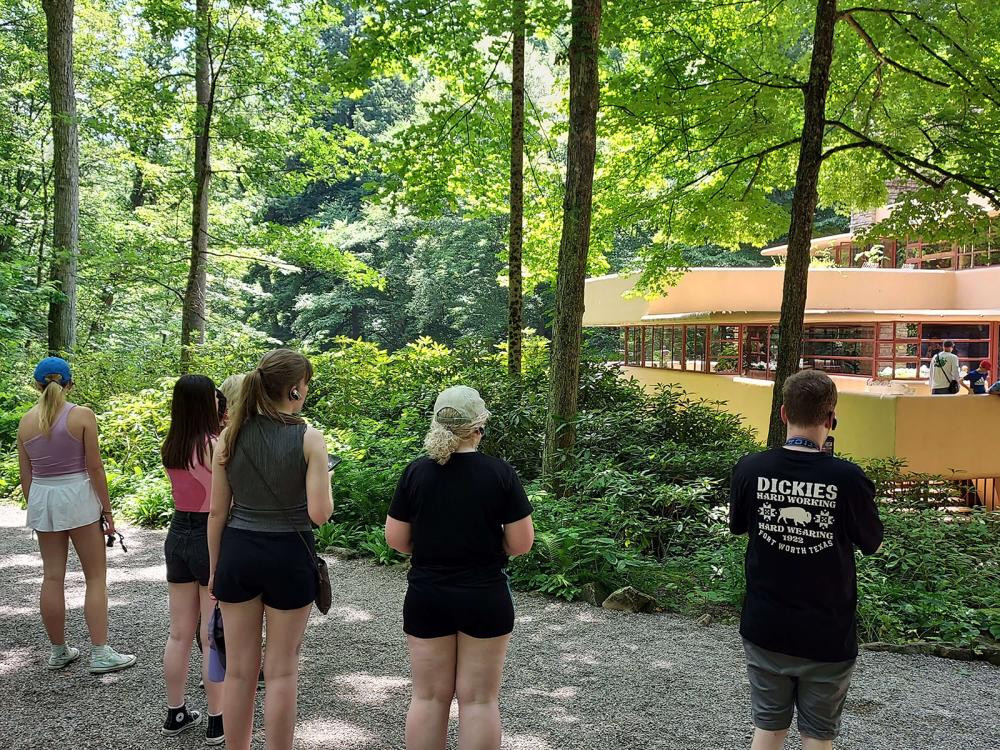 Students standing in front of Fallingwater house.