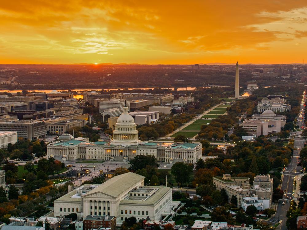 Aerial shot of the U.S. Capitol and Supreme Court Building in Washington, D.C., at sunset
