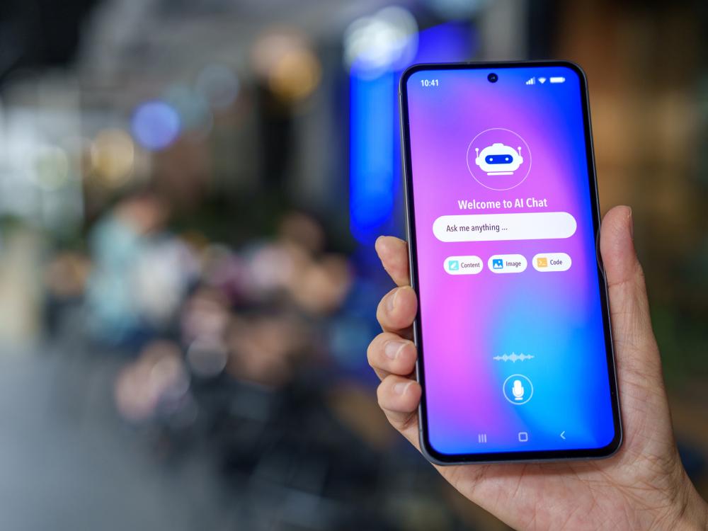 Close-up of a smartphone in a hand, showing an AI chatbot interface