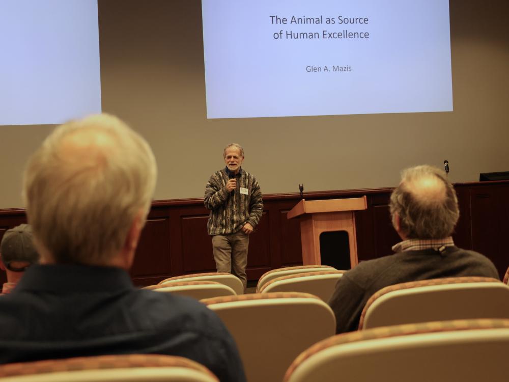 Glen Mazis delivering lecture in front of audience