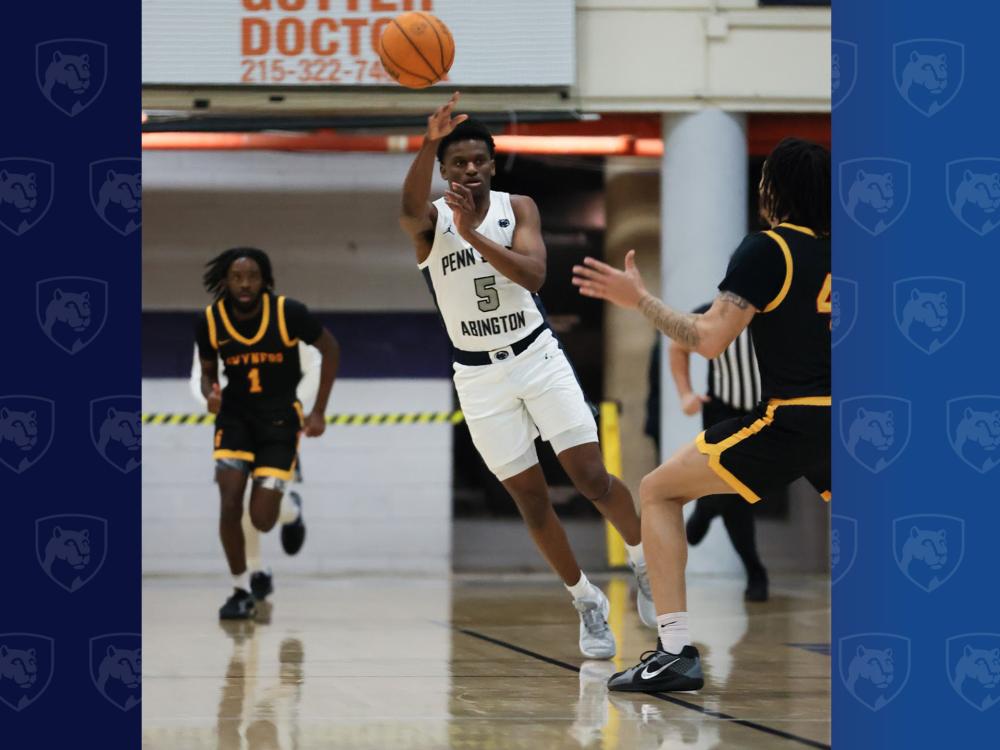 man playing college basketball going up for a shot