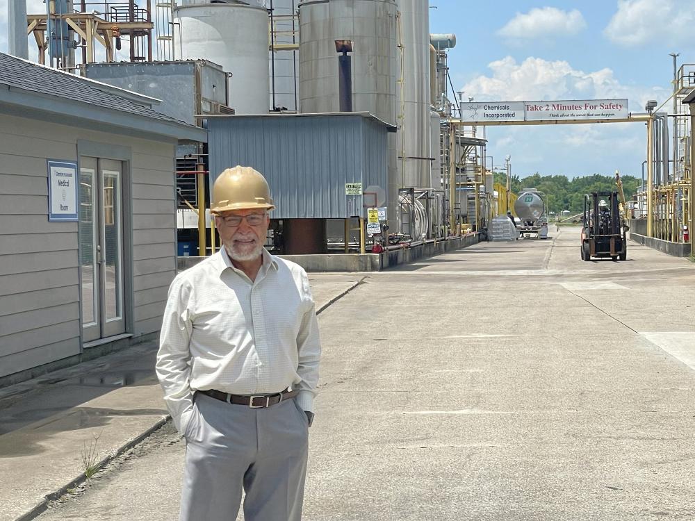 Person in a hardhat standing in a road.