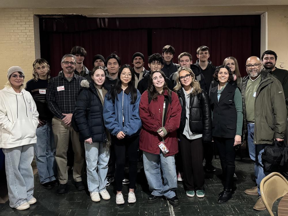 Smiling adults in winter attire standing together posing for a photo.
