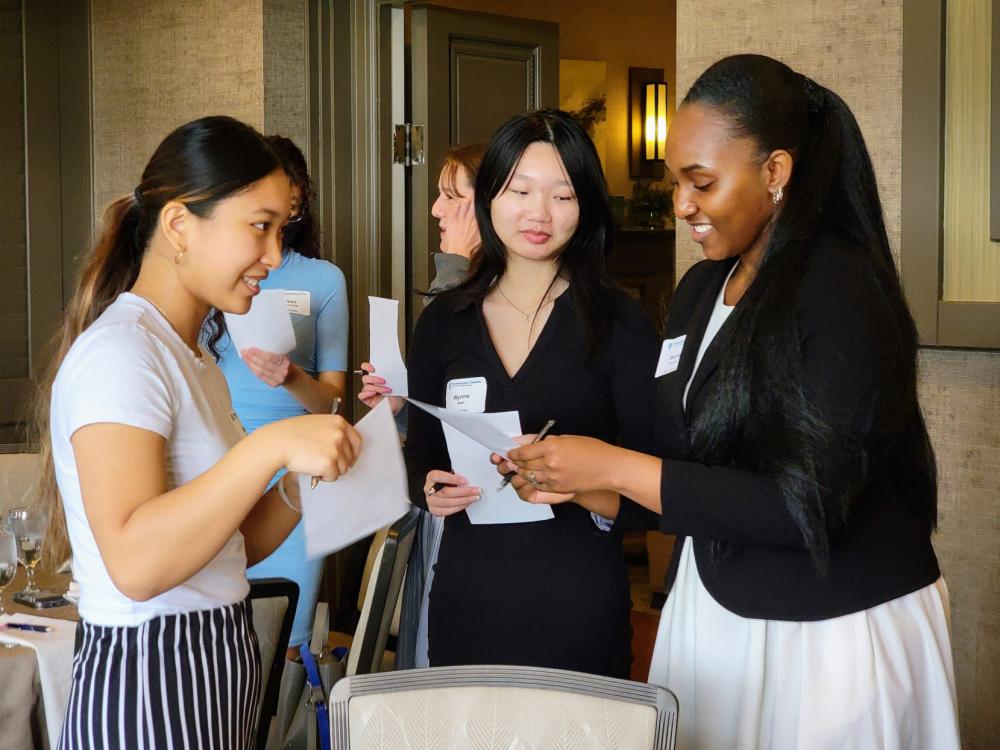Three women talk during a luncheon
