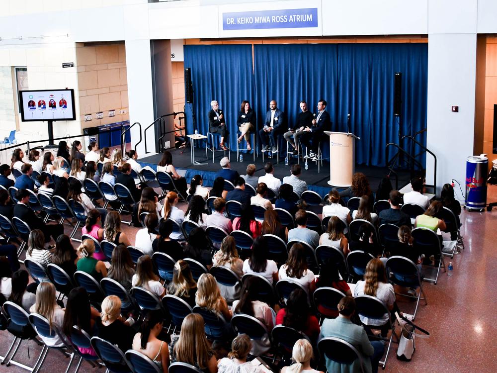 An audience of more than 100 people assembles in front of four panelists and a moderator in the Dr. Keiko Miwa Ross Atrium in the Business Building for the 10th Prime Branding Panel.
