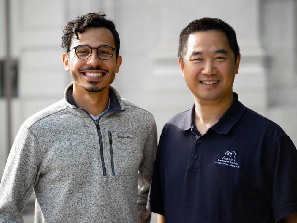 Two researchers posing for the camera outside