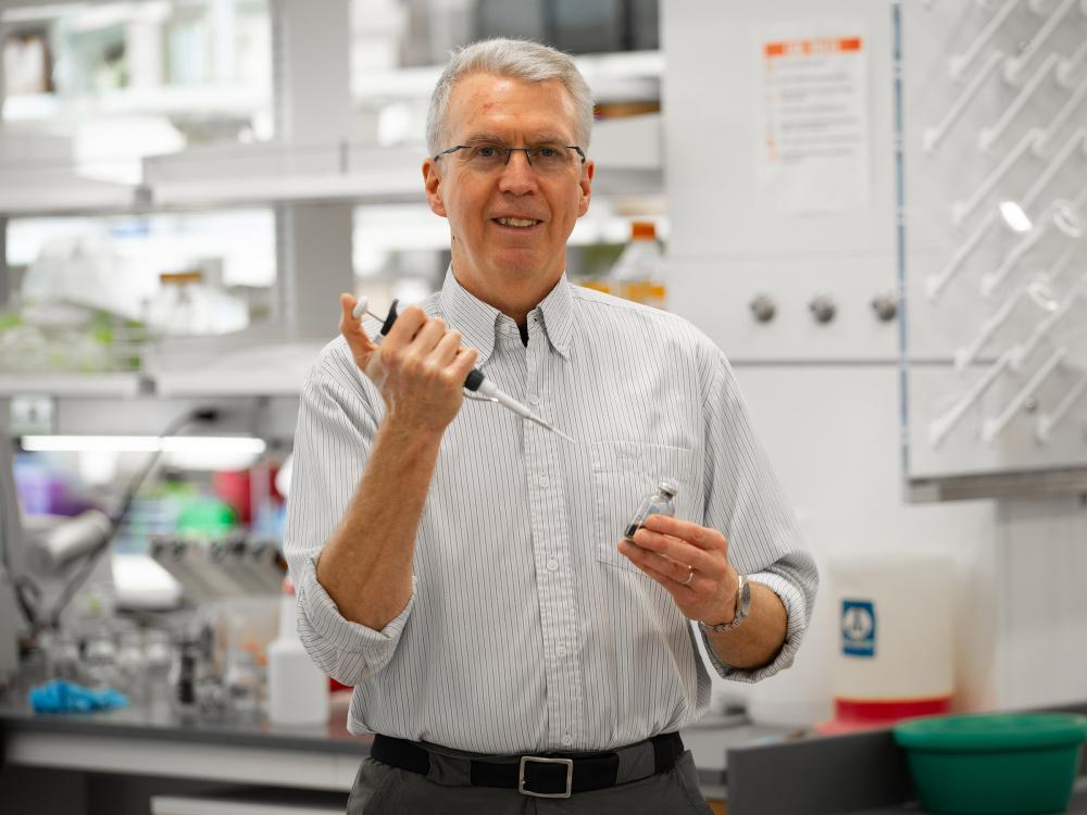Researcher looking at the camera and smiling.