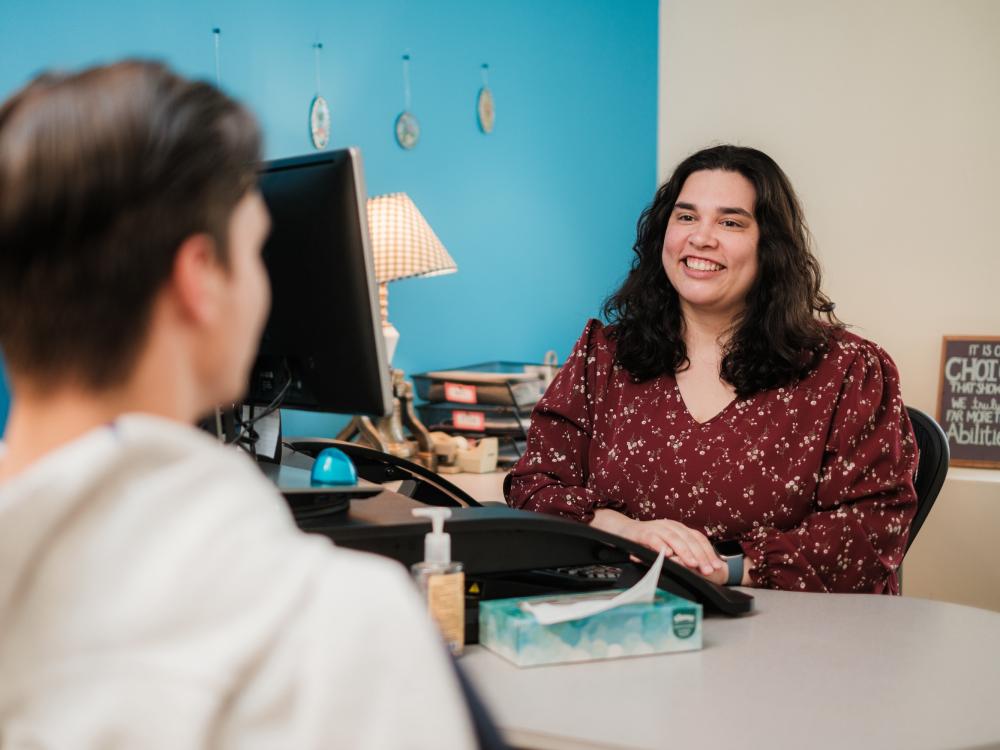 Academic adviser talking to student in office