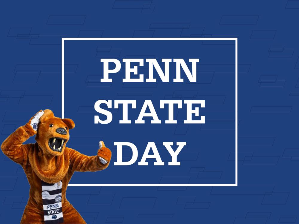 The Penn State Nittany Lion stands in front of the words Penn State Day.