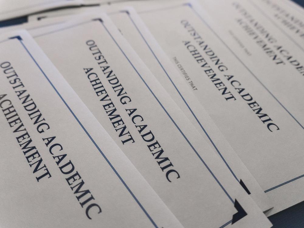 Outstanding academic achievement awards placed on top of table
