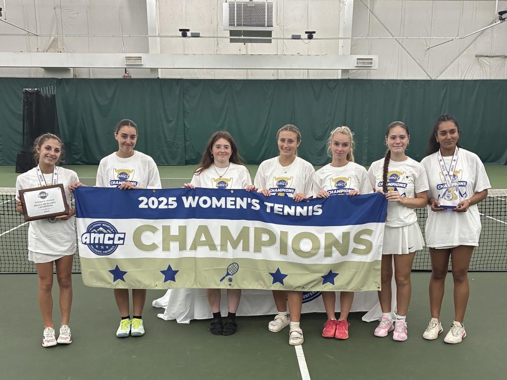 The Penn State Behrend women's tennis team poses with the AMCC championship banner.