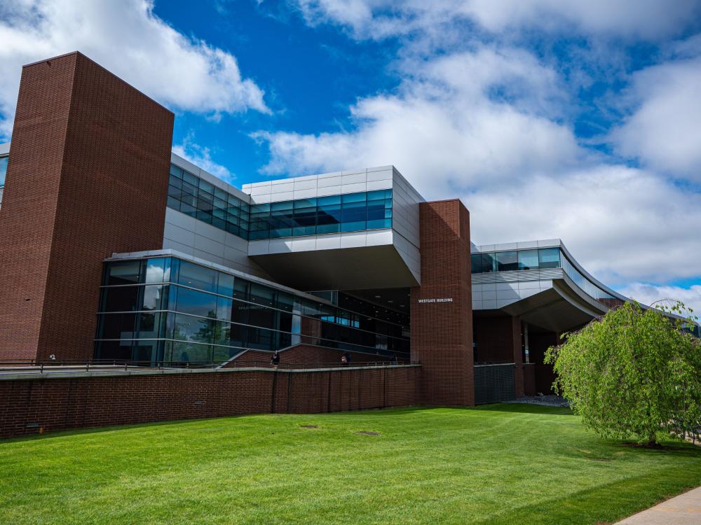 expansive glass and red brick campus building 