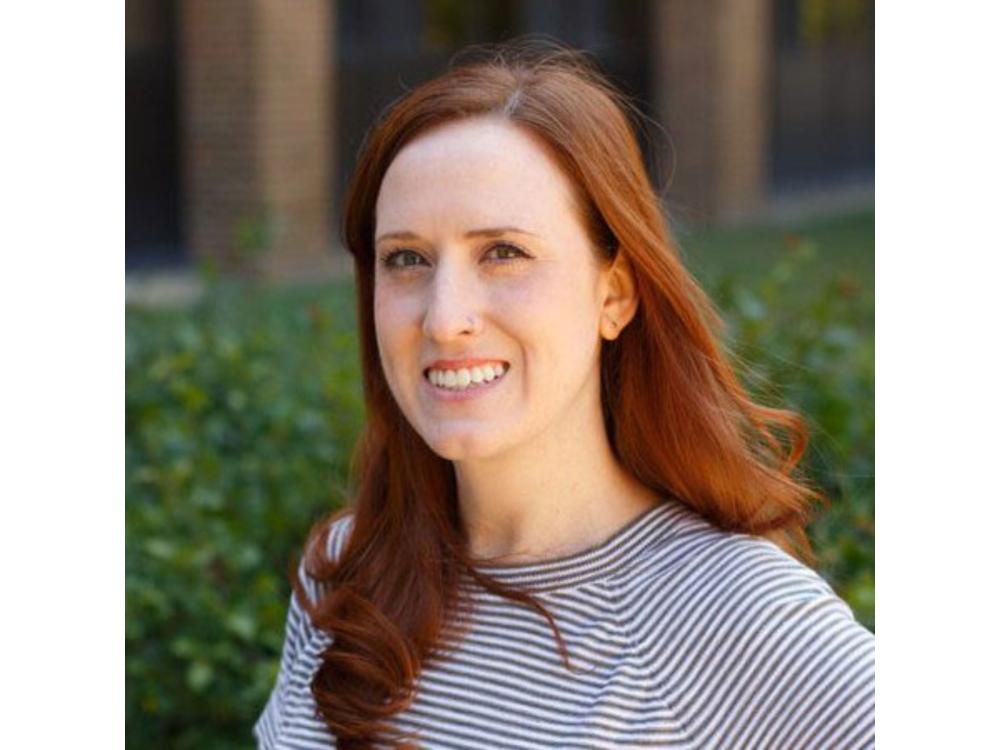 headshot of person with long red hair