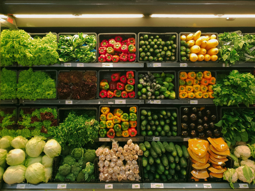 Rows of fruits and vegetables in the produce section of a grocery store