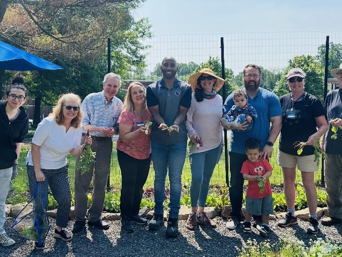 a group of people standing in Penn State Brandywine's garden