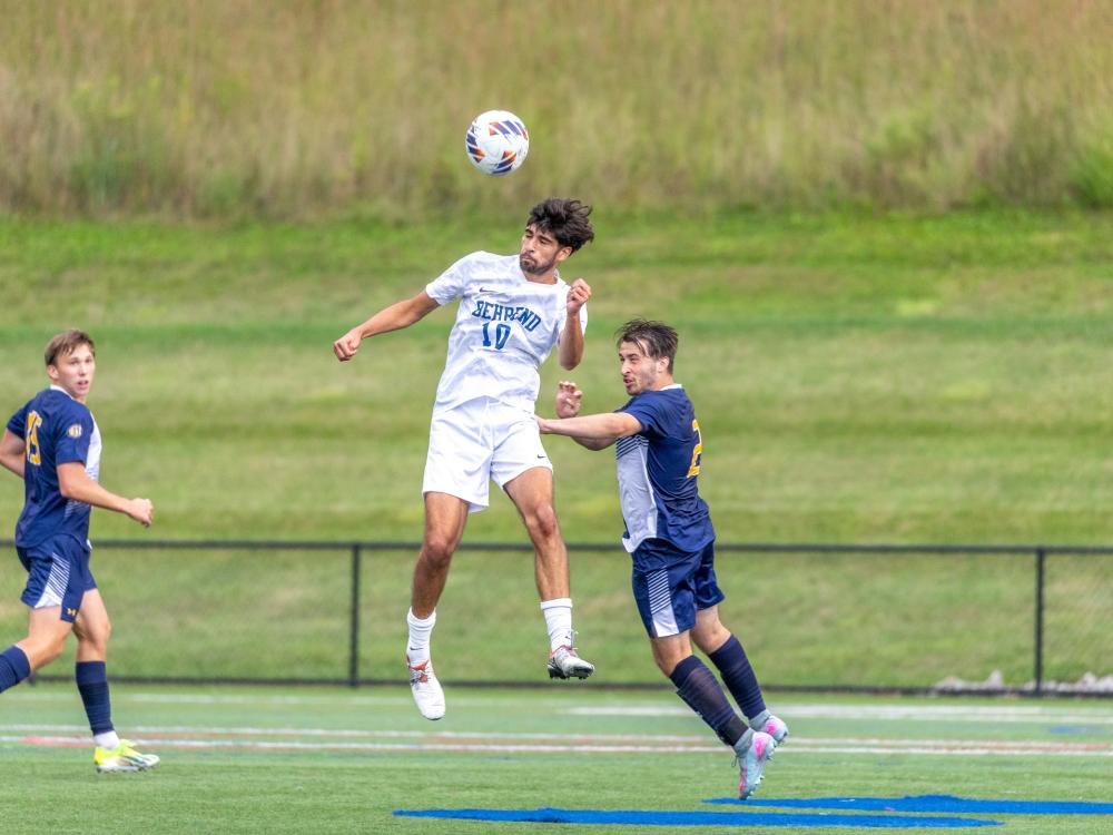 Penn State Behrend soccer player Owen Petersen heads the ball.
