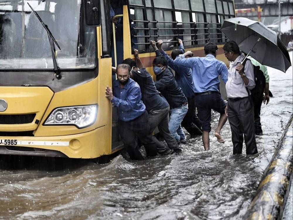 people-pushing-school-bus-in-flood
