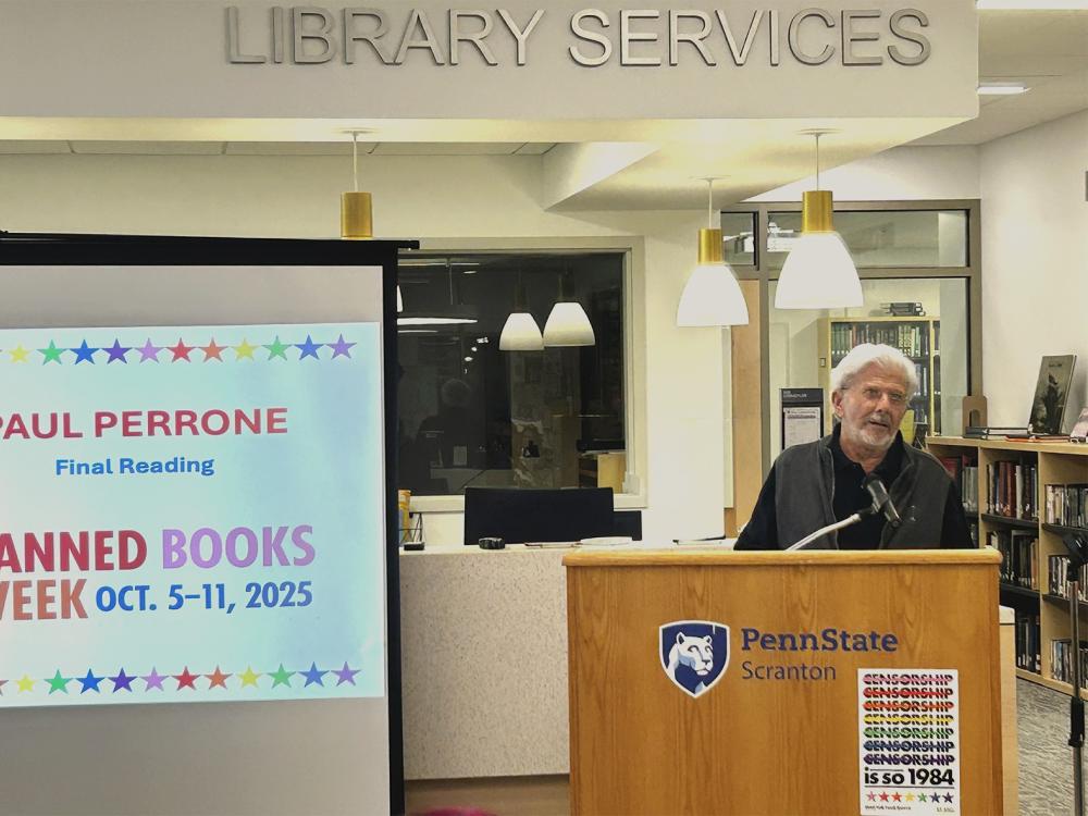 man stands at podium at reading event
