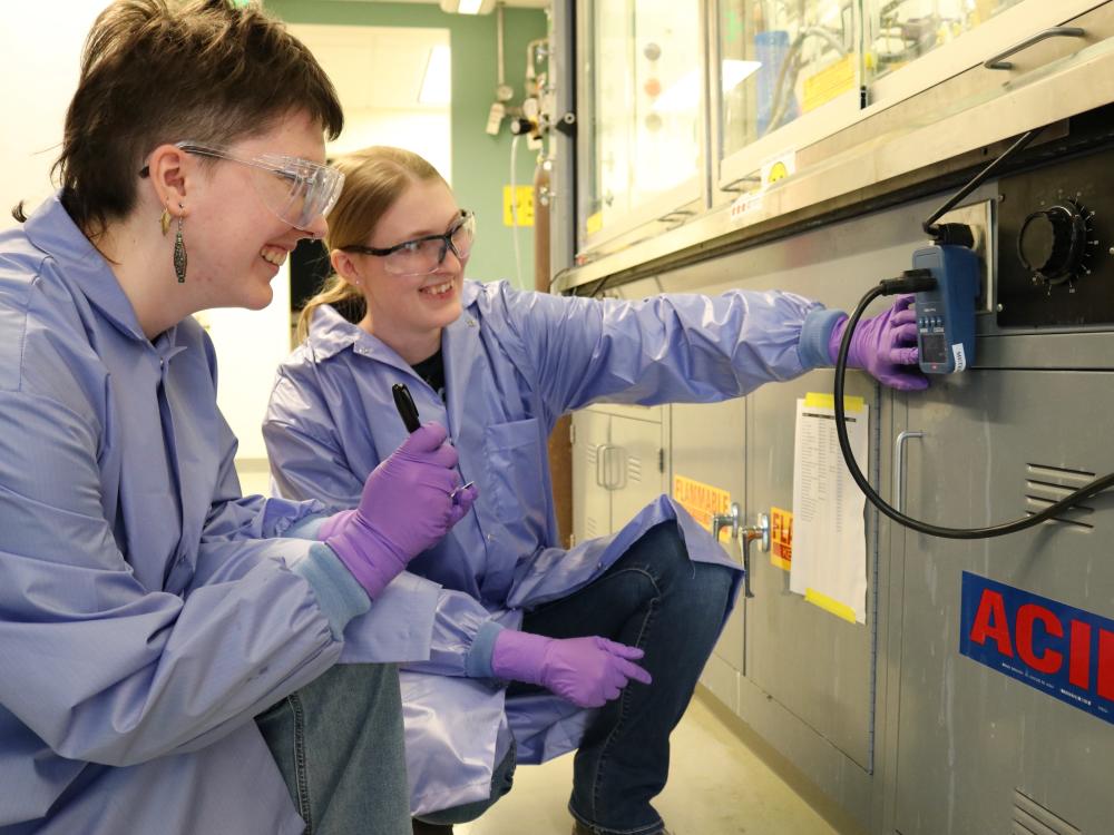 Two people looking at an outlet in a lab
