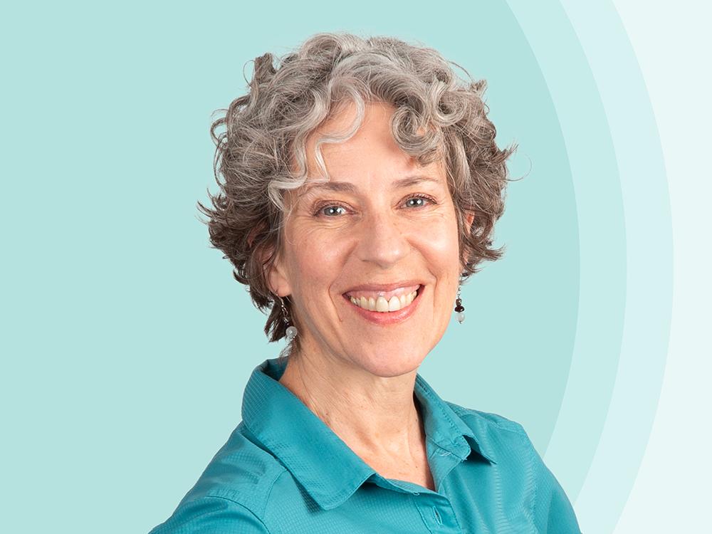Michelle Dunleavy in front of a blue background