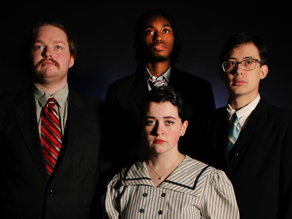 A posed photo of four cast members of "Radium Girls" in a darkened background