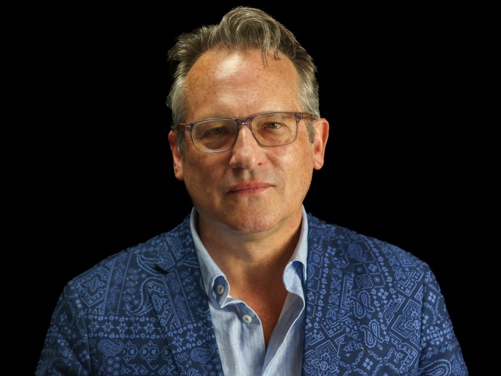 Matthew Restall wears a blue paisley jacket and blue shirt