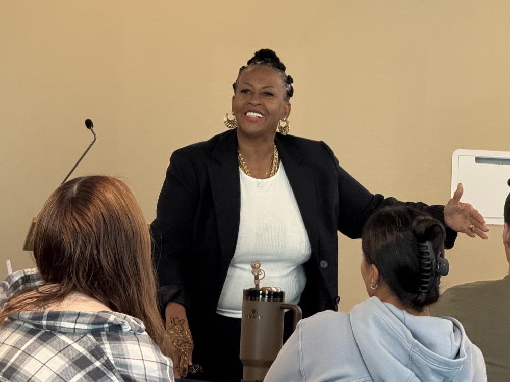 Rev. Dr. Michelle Simmons speaking in front of the room at Penn State Lehigh Valley with a smile and gesturing with her hands.
