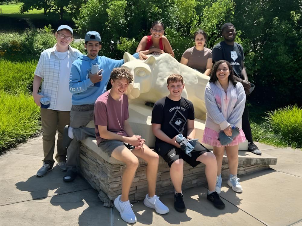 Students in the 2025 Summer Bridge program pose by the Nittany Lion Shrine on the Penn State York campus