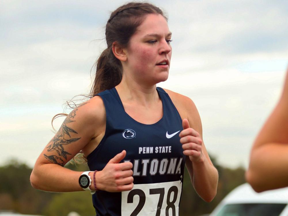 Victoria Scutti running in a cross country meet