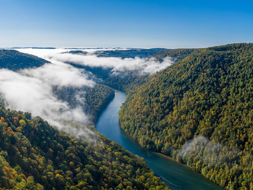 Aerial drone image of the Cheat River flowing through narrow wooded gorge in the autumn towards Cheat Lake near Morgantown, WV